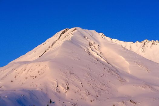 Baikal mountains in winter in snow. Forest in snow-covered mountains.