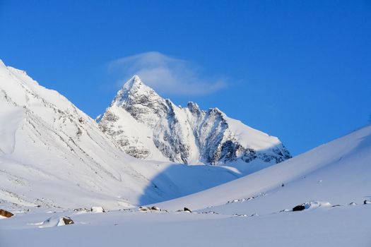 Baikal mountains in winter in snow. Forest in snow-covered mountains.