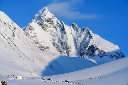 Baikal mountains in winter in snow. Forest in snow-covered mountains.