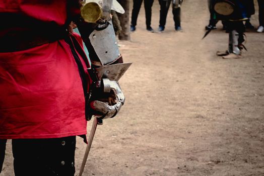 Medieval knight preparing to fight at a tournament. Close up detail of the hand holding a sword.