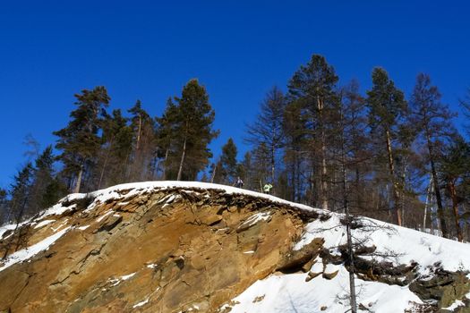 Baikal mountains in winter in snow. Forest in snow-covered mountains.