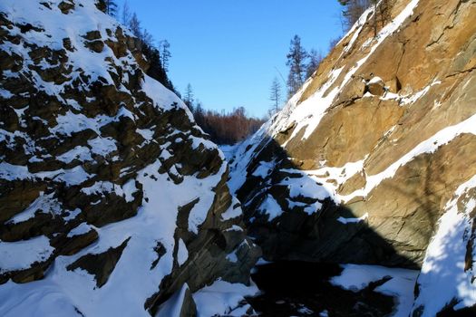 Baikal mountains in winter in snow. Forest in snow-covered mountains.