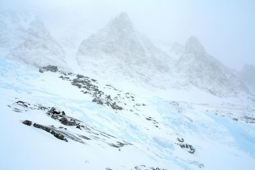 Baikal mountains in winter in snow. Forest in snow-covered mountains.