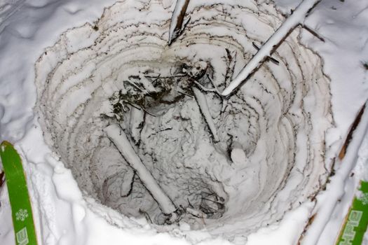 A hole in the snow to store food.