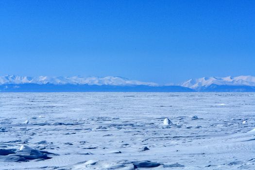 The shore of Lake Baikal in winter. Snow and ice on the baikal.