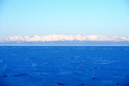 The shore of Lake Baikal in winter. Snow and ice on the baikal.