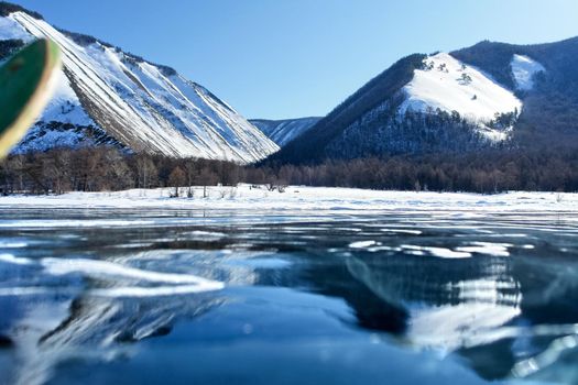 The shore of Lake Baikal in winter. Snow and ice on the baikal.