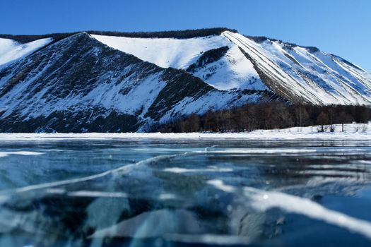 The shore of Lake Baikal in winter. Snow and ice on the baikal.