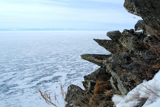 The shore of Lake Baikal in winter. Snow and ice on the baikal.