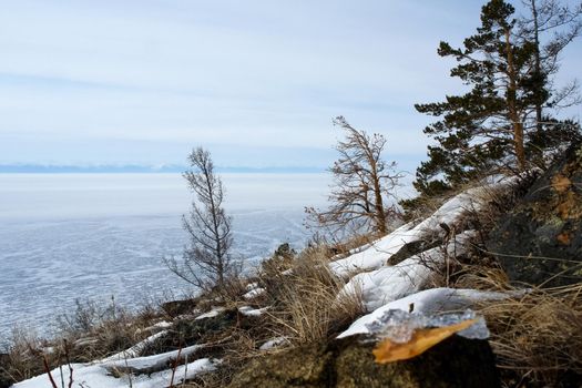 The shore of Lake Baikal in winter. Snow and ice on the baikal.