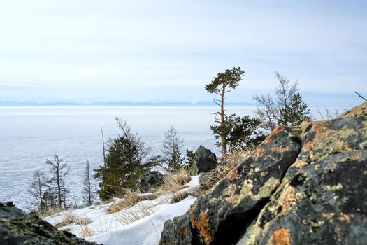 The shore of Lake Baikal in winter. Snow and ice on the baikal.