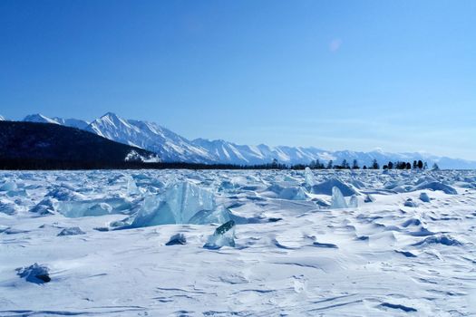 The shore of Lake Baikal in winter. Snow and ice on the baikal.