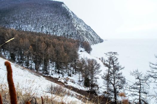 The shore of Lake Baikal in winter. Snow and ice on the baikal.