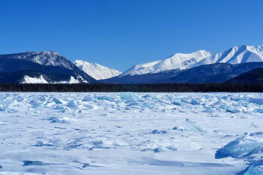 The shore of Lake Baikal in winter. Snow and ice on the baikal.