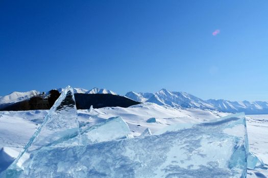 The shore of Lake Baikal in winter. Snow and ice on the baikal.