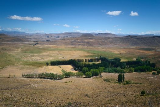 An isolated hacienda in the middle of an vast prairie