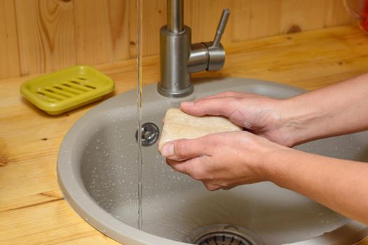 Girl's hands soaping their hands with soap in the kitchen sink