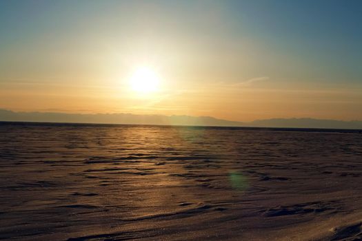 The winter landscape of Lake Baikal. Beautiful mountains in the snow and sky