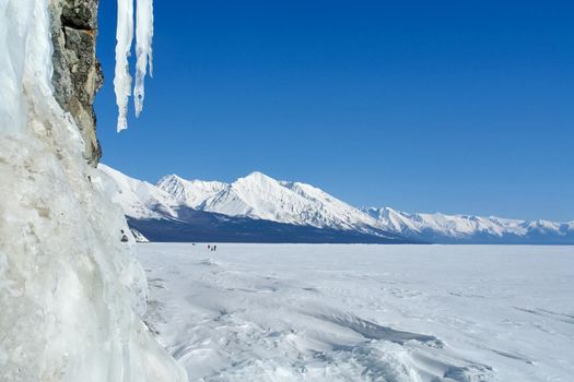 The winter landscape of Lake Baikal. Beautiful mountains in the snow and sky