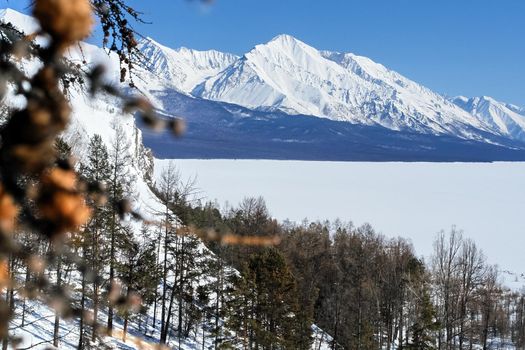 The winter landscape of Lake Baikal. Beautiful mountains in the snow and sky