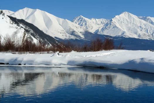 The winter landscape of Lake Baikal. Beautiful mountains in the snow and sky