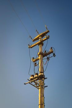 Electrical pylon and power lines against blue sky. Infrastructure, power supply concept.