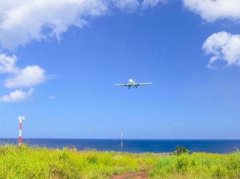 A plane taking off over the easterly island coast.
