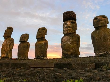 Statues of Easter Island in the background of the sunset. The melting of the Easter statue in the sunlight of the sunset.