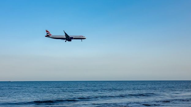 April 11, 2019 Larnaca, Cyprus. Plane of airline 
British Airways comes in to land over the waters of the Mediterranean sea.