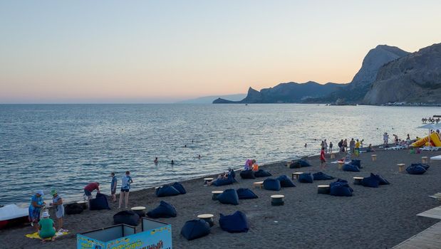July 21, 2017, Sudak. Vacationers on a warm evening on the city beach in Sudak.