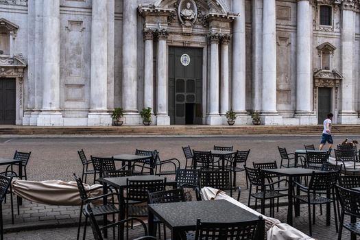 Picture shows deserted outdoor tables and chairs in front of the New Cathedral in Paul VI square in Brescia. Lockdown measures taken in Italy over the coronavirus pandemic will be extended until May.