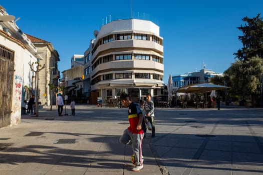 April 22, 2019, Limassol, Cyprus. Children play soccer in the city square .