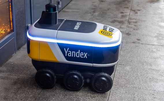 December 14, 2020, Moscow Russia. An unmanned robot courier for delivering food from the Yandex.Rover cafe at the entrance to a restaurant in Moscow.