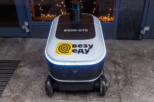 December 14, 2020, Moscow Russia. An unmanned robot courier for delivering food from the Yandex.Rover cafe at the entrance to a restaurant in Moscow.