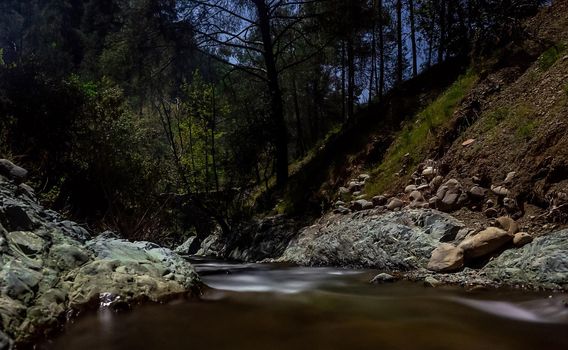 Rapid flow of the river in the mountains of the island of Cyprus at dusk.