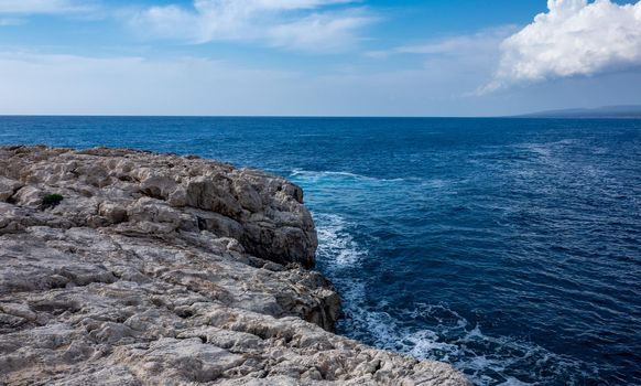 Waves crash on the rocky shore of the Mediterranean Sea on the Akamas Peninsula in the northwest of the island of Cyprus.
