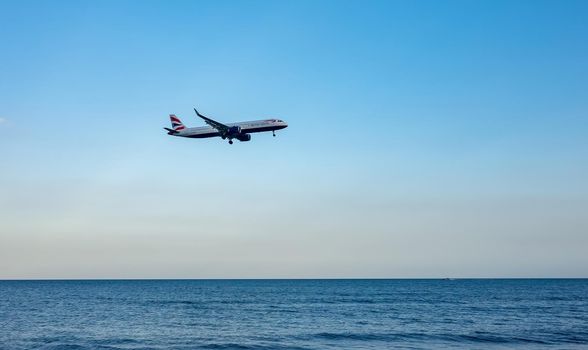 April 11, 2019 Larnaca, Cyprus. Plane of airline 
British Airways comes in to land over the waters of the Mediterranean sea.