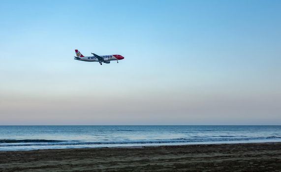 April 11, 2019 Larnaca, Cyprus. Plane of airline 
Edelweiss Air comes in to land over the waters of the Mediterranean sea.