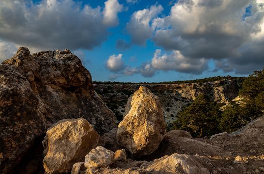 Sandy mountain road of the island of Cyprus in the light of the setting sun.