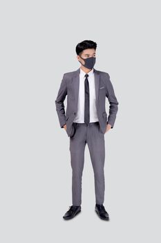 Portrait young asian businessman in suit wearing face mask for protective covid-19 isolated on white background, business man and healthcare, quarantine for pandemic coronavirus, new normal.