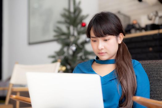 Business young asian woman freelance work on display laptop computer on chair, businesswoman check email, asia girl searching to internet communication and business concept.