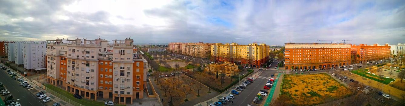 Wide panoramic view of the street with modern buildings and streets with cars, spring, Spain