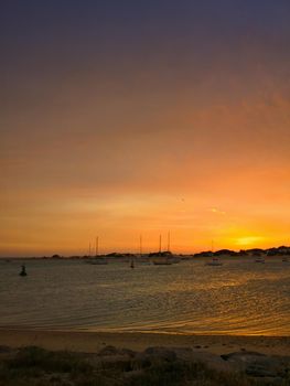 Sunset on the big bay and small sailboats, seashore, spring, Spain