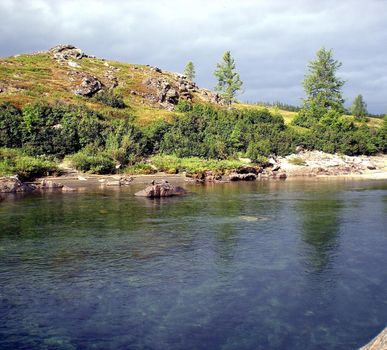 River in the taiga in northern Russia. The nature of the taiga in a mountainous area.