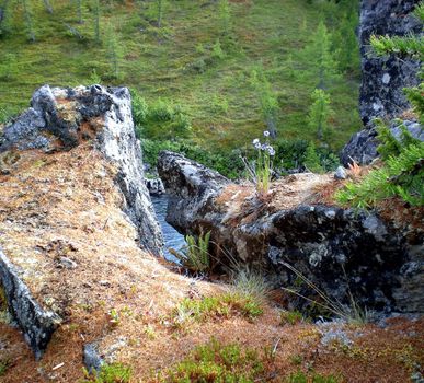 A stone gorge to the bank of a mountain river. The rocky bank of the river.