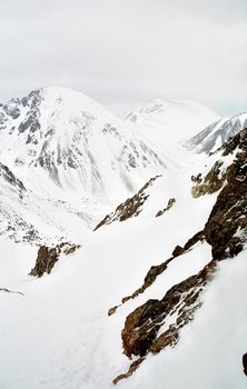 Mount Sayan in winter in the snow. The nature of the mountains is sayan.