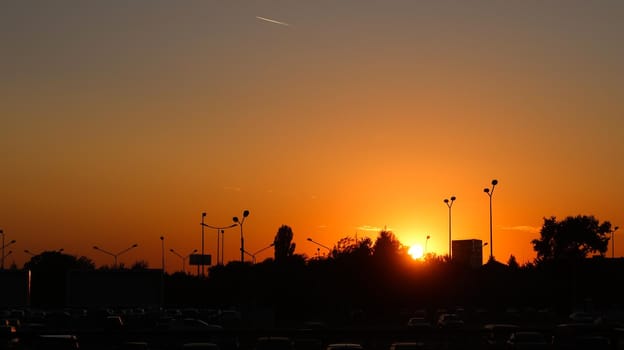 Fire sunset with backlit street light and trees