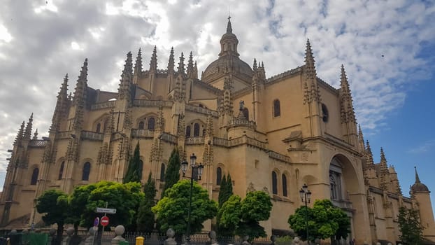 Beautiful shot of the Segovia Cathedral on the cloudy sky background