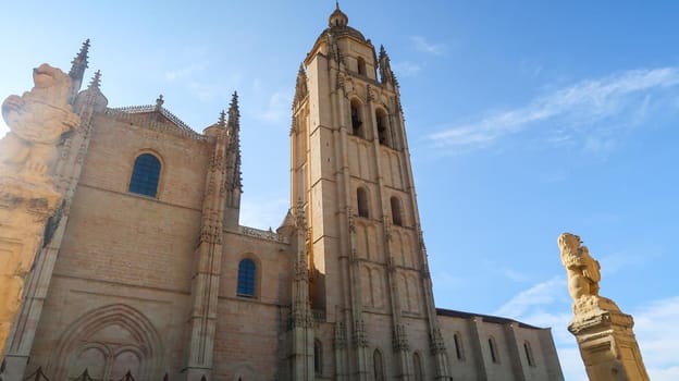 Horizontal shot of the facade of Segovia Cathedral, a sculpture in the foreground