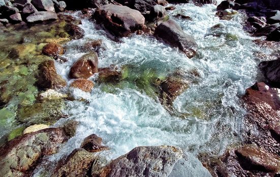 Mountain river. Stones and water of a mountain river. The mountains are said.